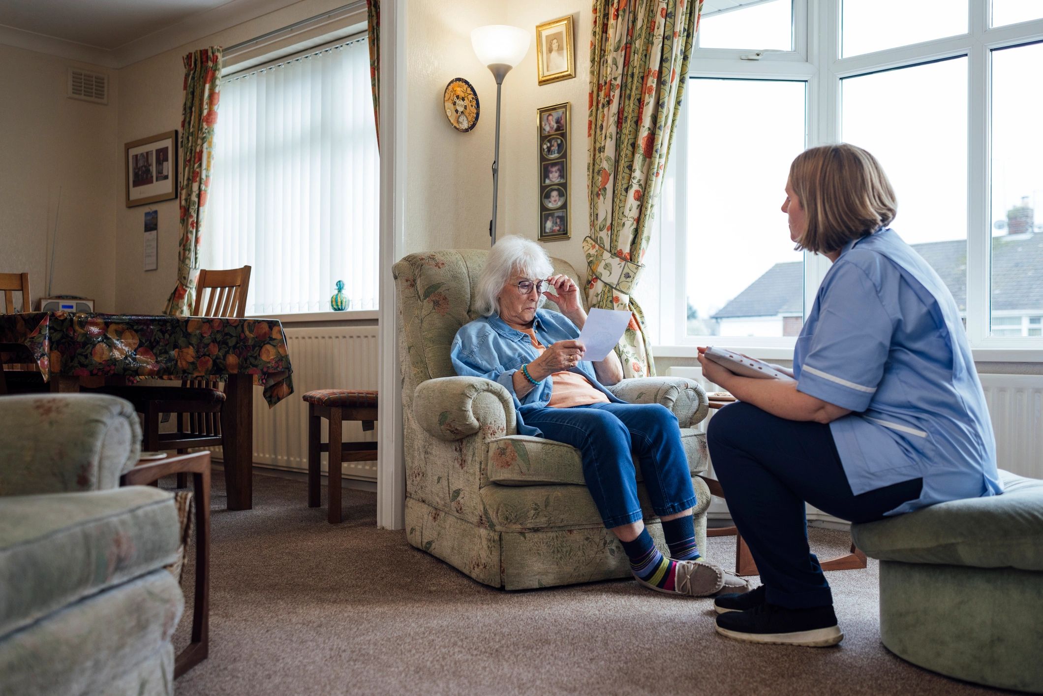 Senior woman reviewing information with a home caregiver